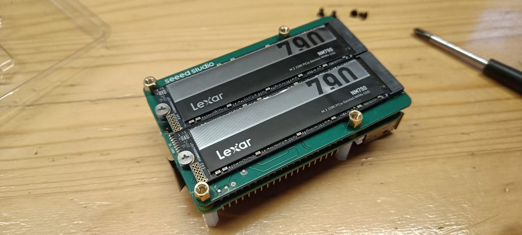 Picture showing my Nextcloud hardware, consisting of a Raspberry Pi on its back with an M.2 head and two SSD modules. Case is still removed.